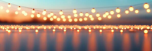 String lights glowing against a colorful sunset sky during an evening gathering photo