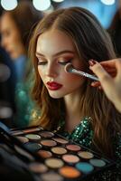 Makeup application on a model during a beauty shoot in a professional studio setting photo