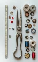 Crafting supplies and tools neatly arranged on a white background with various threads and buttons photo