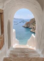A beautiful coastal view through an archway on a sunny day with boats in the distance photo