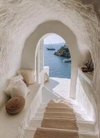 A beautiful coastal view through an archway on a sunny day with boats in the distance photo