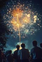 Spectacular fireworks illuminate the night sky over a gathering crowd during a festive celebration photo
