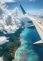 Flying over a picturesque coastline with brilliant blue waters and fluffy clouds in daylight photo