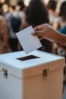 A person casting a ballot into a white voting box during a public election in a busy venue photo