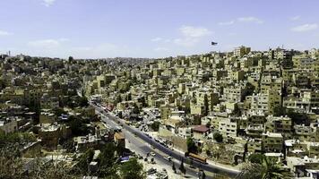 A panoramic view of a vibrant cityscape with rolling hills and unique architecture. Action photo