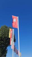 View of some state flags of German federal states including Schleswig-Holstein in front of a deep blue sky. video