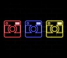 Glowing neon line Photo camera icon isolated on brick wall background. Foto camera icon. Colorful outline concept. vector