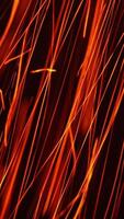 Quick orange scintilla flying vertically down. Hot particles at a fast speed at black background. Close up. Vertical video