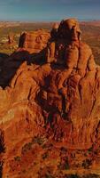 Unusual sunlit mount with rounded edges in the middle of desert. Panning footage of beautiful rock in the Utah Canyons, USA. Vertical video