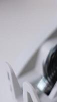 American banknotes rotating quickly in the slot of cash counting machine. Close up. Blurred background. Vertical video