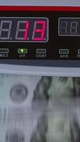 Control panel of cash counting machine. US dollars being counted in the device. Close up. Vertical video