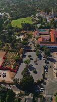 Sunny scenery of a green city with rich architecture and lots of greenery. Footage over the traffic roads of Santa Barbara, California, USA. Vertical video