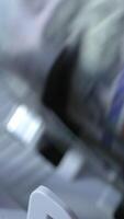 Counting mechanism processing one hundred dollar bills. Close up. Investment capital operations concept. Vertical video