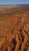 Deserted landscape with amazingly-shaped rocks from air erosion. Arches National Park canyons from aerial view. Vertical video