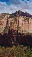 Tremendous rocks of Zion National Park on beautiful sunny day. Beautiful blue skies with lovely clouds at backdrop. Aerial view. Vertical video