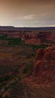 Scenic view of canyons in Utah, USA. Cloudy grey skies over the rocks and plains in eye-catching national park. Top view. Vertical video