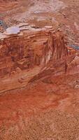 Outstanding high orange rocks of Bryce canyon in Utah, USA. Flying over the rounded tops of rocks and highway with cars passing by. Aerial view. Vertical video