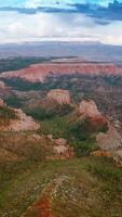 Amazing scenery of stunning mountains in Zion National park, Utah, USA. Cloudy sky over great canyons at backdrop. Aerial view. Vertical video