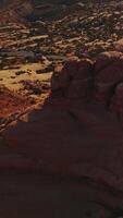 Odd rounded tops of the rock in the beautiful national park of America. Car going by the speed highway round the mount. Top view. Vertical video
