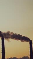 Smoking pipes making clouds. Multiple exposure of poor environment in cityscape pollution with heavy smoke from industrial chimneys video