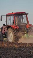 Tractor working in the field. Tractor cultivating and seeding a dry field video