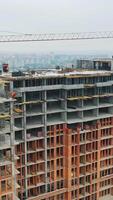 Construction site from height. Drone aerial view of new development with cityscape in background video