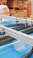 Robotic equipment on a factory. Metal construction of automated technologies inside the industrial plant. Conveyor line at working process. Vertical video