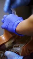Practical course on a dummy's head. Student trying medical exercise at giving a resuscitation on a mannequin in the training center. Close-up. Vertical video