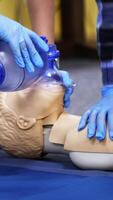 Exercise for life saving in emergency. Demonstration of CPR on manikin. Teaching method pressing on the chest on a dummy in the medical room. Vertical video
