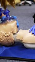 Training compression on a dummy. CPR exercise on a mannequin in the medical center. Teaching skills during heart attack. Vertical video