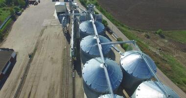 Grain Elevators And Granaries. Aerial view of big grain elevators in sunny summer day video