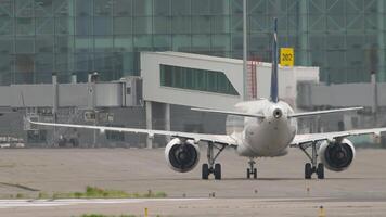 Shot of a jet passenger plane with an unrecognizable livery taxiing to the terminal. Airliner on the apron. video