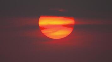 Large round orange sunset with texture of cloudy sky for background , big and powerful sun shot video