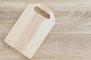 Top view chopping board on wood table photo