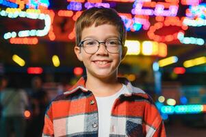 A handsome and happy boy is having fun in the amusement park photo