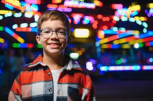 A handsome and happy boy is having fun in the amusement park photo