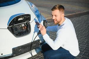Man turning on charging of car photo