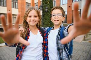 Portrait of smiling school kids standing at school yard photo