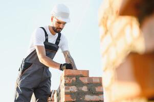 Construction worker in uniform and safety equipment have job on building. Industrial theme photo