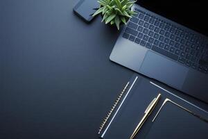A sleek workspace featuring a laptop, notebook, and greenery for productivity and inspiration photo