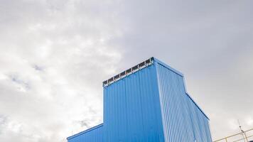 Blue Building Against Cloudy Sky photo
