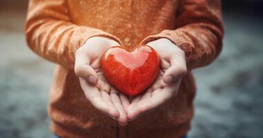Close up of child hands holding a red heart. A boy with a red heart, mother's day. video