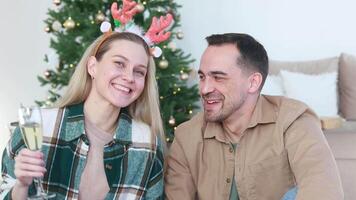 A married couple communicates with each other and with relatives or subscribers via conference or online broadcast. New Year and Christmas. video