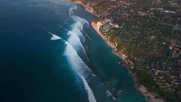 Drone view of coastline with cliffs and ocean with surfing waves in Bali video