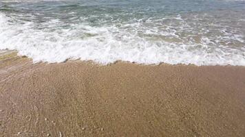 water of the waves on the shore of a beach on a day with the most calm, concept of summer background video