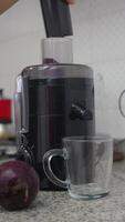 Preparing beet juice in a fruit and vegetable juicer. video