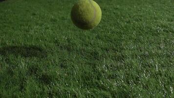 Super Slow Motion Shot of tennis ball and tennis racket at 1000 fps at natural grass during rain. Sport concept super slow motion shot on high speed camera 1000 fps. video