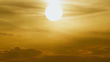 sunset with the glowing sun shining through the clouds, bathing the sky in warm golden light video