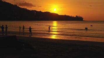 Time lapse of sunset on the beach. The sun sets behind the hill, warm season. video