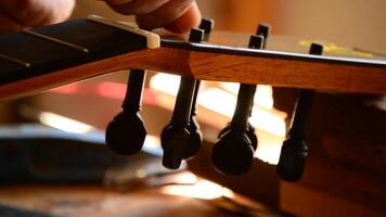 Luthier placing a string of a guitar video